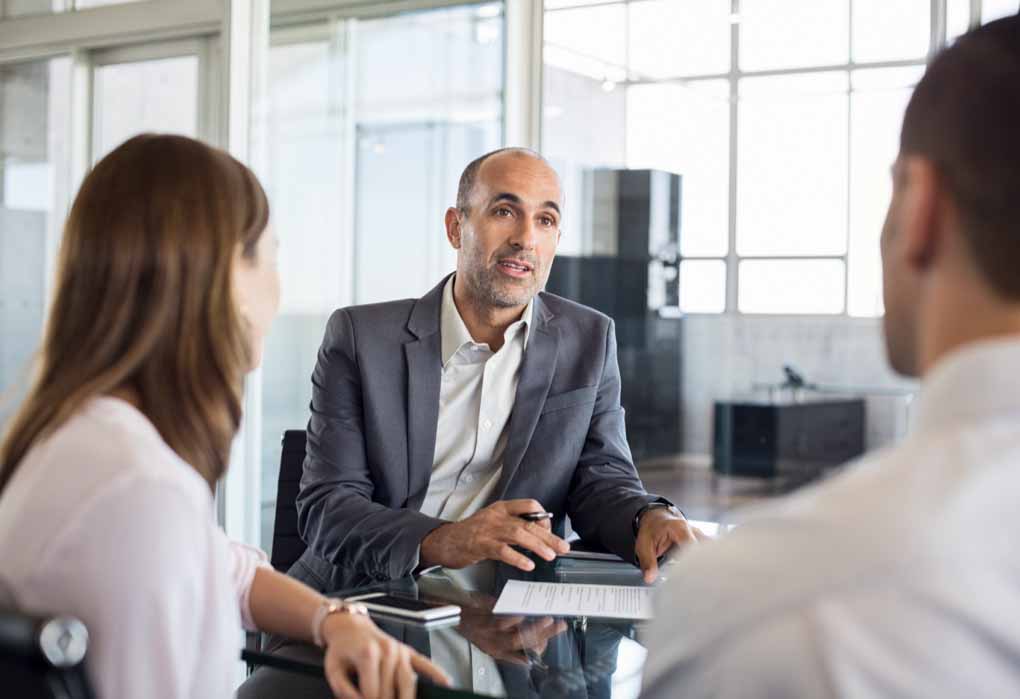 A roup of people meeting in an office.